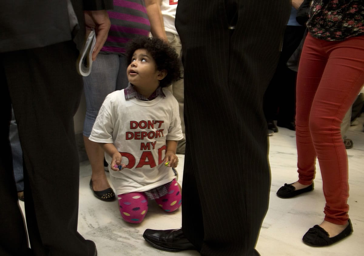 Jackelin Alfaro, 4, in a T-shirt that reads &quot;Don't Deport my Dad&quot; sits in the hall with family members outside the House Judiciary Committee hearing on Capitol Hill in Washington on Tuesday.
