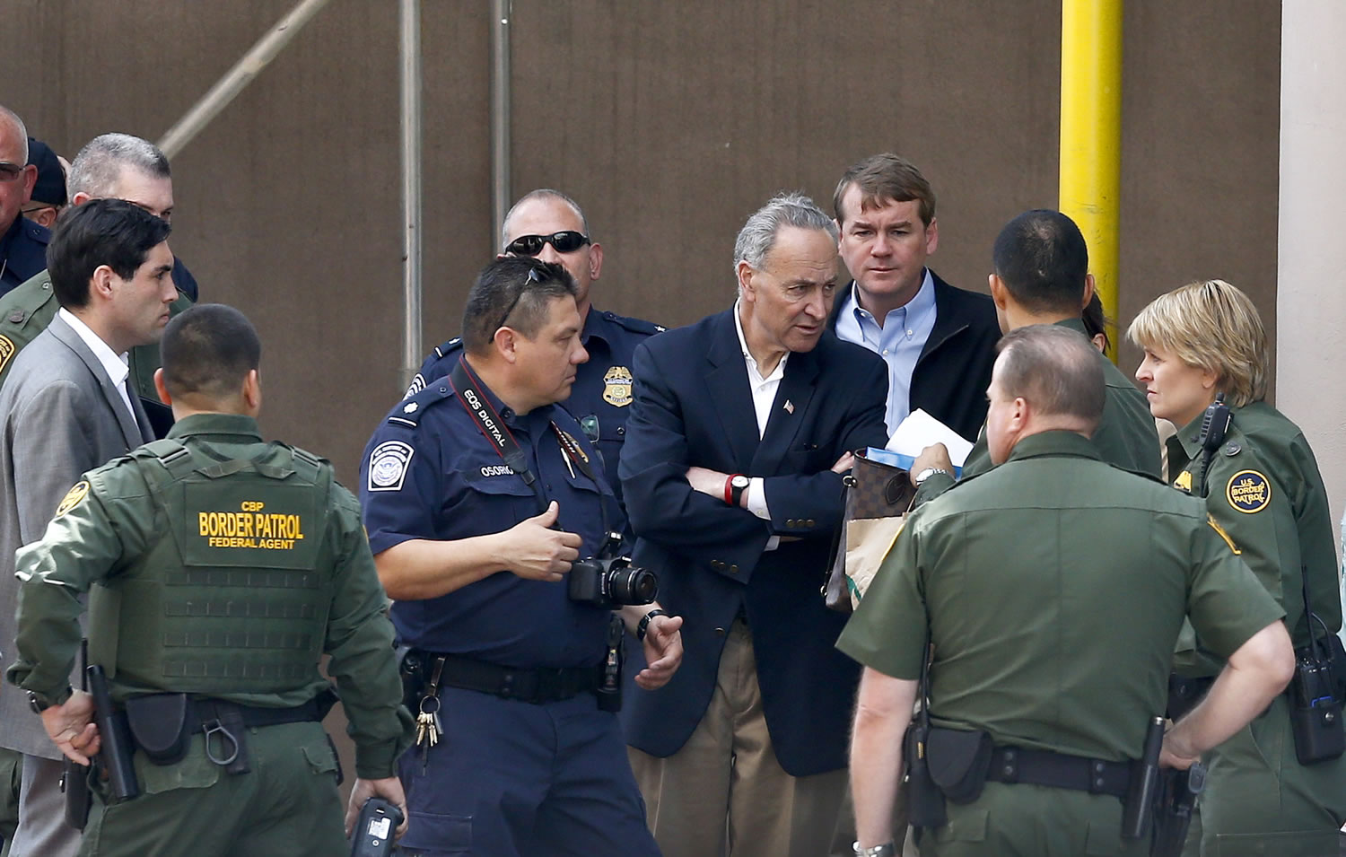 Sen. Chuck Schumer, D-NY, center, and Sen. Michael Bennett, D-CO, rear, speak with U.S. Border Patrol agents and U.S. Customs and Border Protection agents   during their tour of the Mexico border with the United States on Wednesday, March 27, 2013, in Nogales, Ariz. (AP Photo/Ross D.