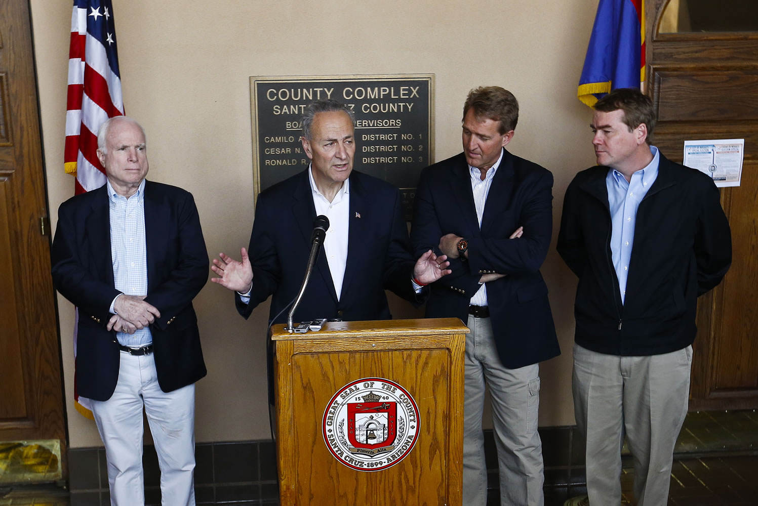 From left, Sen. John McCain, R-Ariz., Sen. Chuck Schumer, D-N.Y., Sen. Jeff Flake, R-Ariz., and Sen. Michael Bennett, D-Colo., address the media during a news conference after their tour of the Mexico border with the United States on March 27 in Nogales, Ariz.