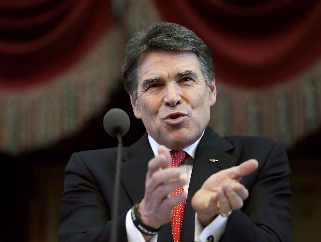 Eric Gay/Associated Press files
Gov. Rick Perry delivers the State of the State address Jan. 29 in the House chambers at the state Capitol in Austin, Texas. Perry is hunting for new businesses to move from California to Texas.