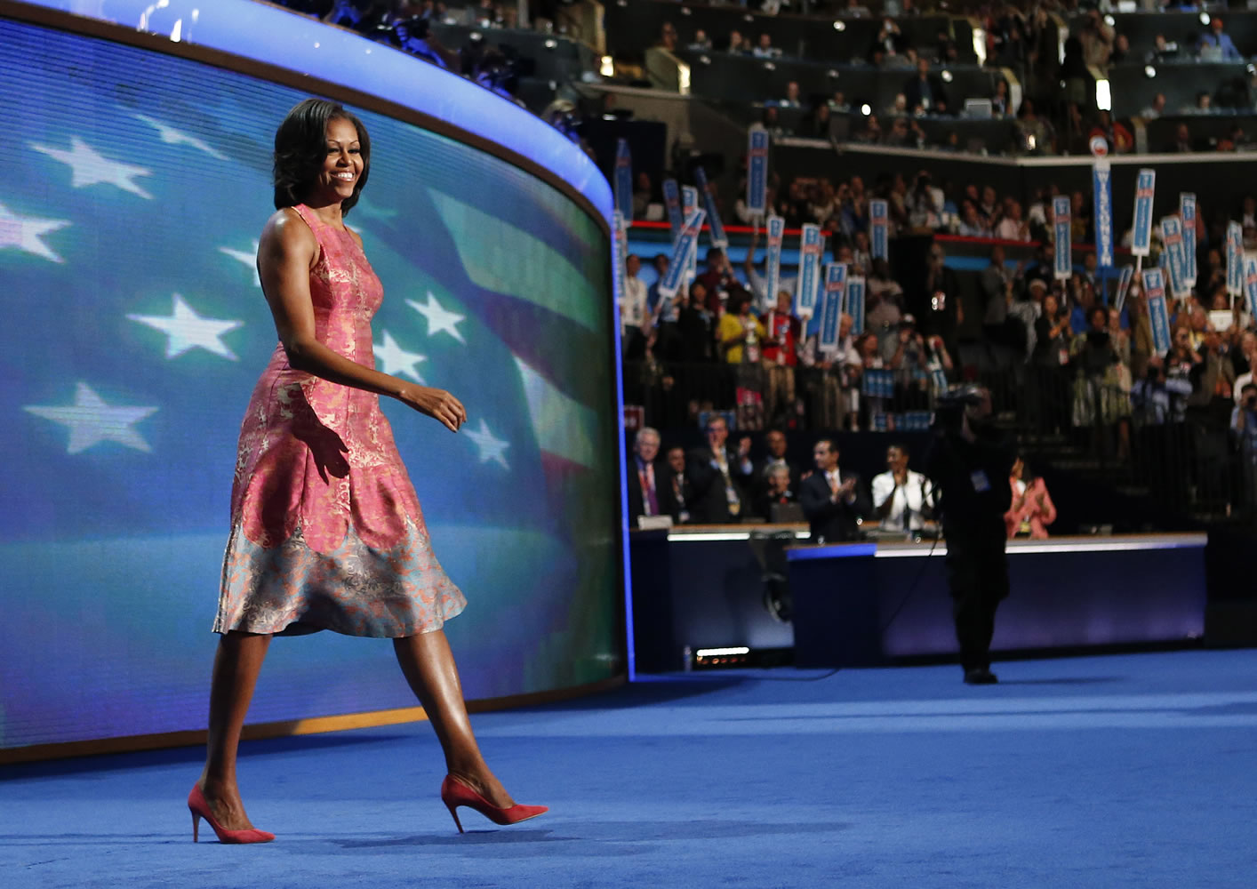 FILE - In this Tuesday, Sept. 4, 2012 file photo, first lady Michelle Obama walks onto the stage at the Democratic National Convention in Charlotte, N.C.  Obama's dress was designed by Tracy Reese. Obama has proven her fashion savvy time and time again since she was introduced to the country as first lady on Inauguration Day 2009. In the past four years she has adeptly walked the line between directional fashionista and everywoman. (AP Photo/Jae C.