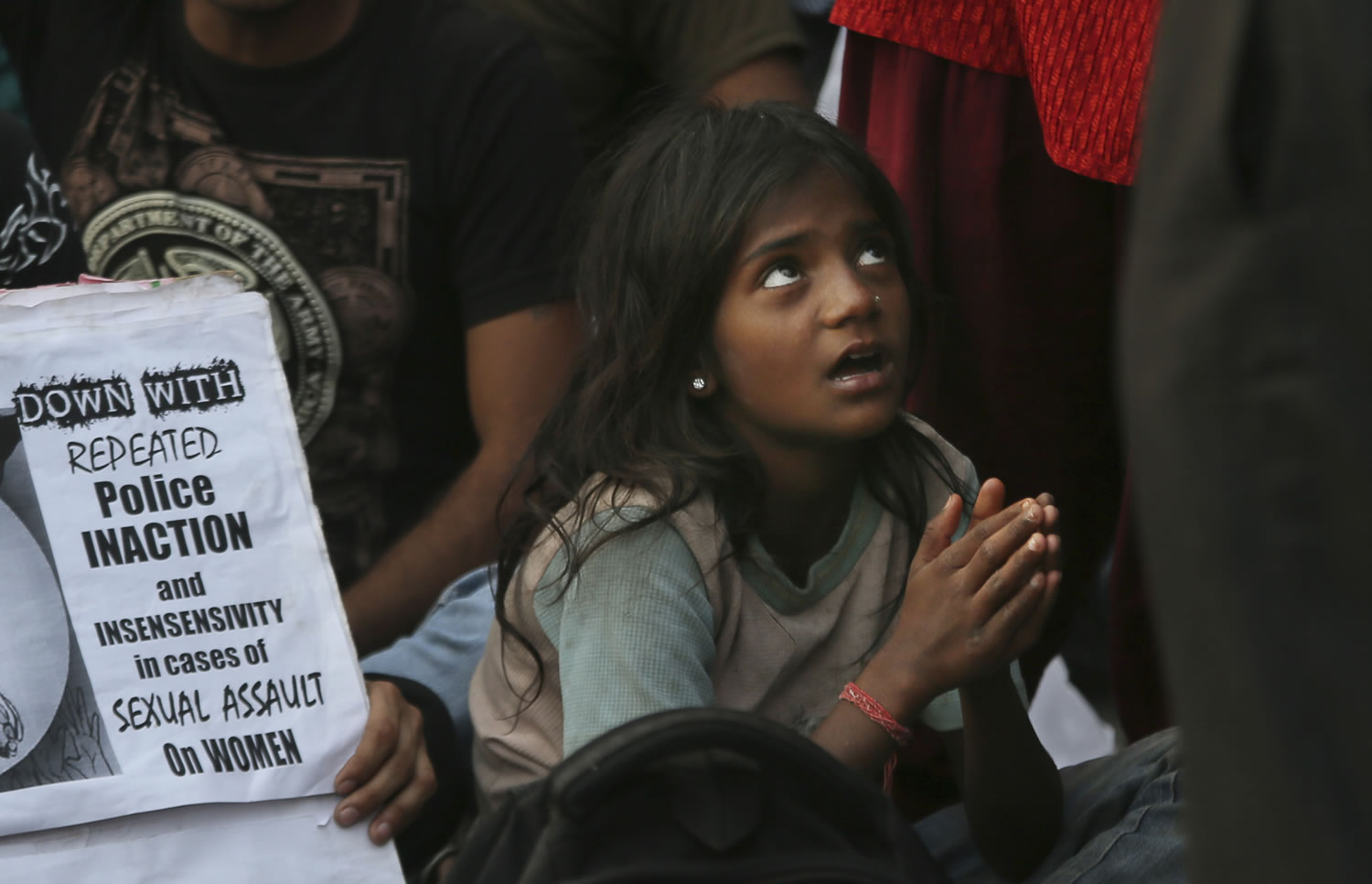 An Indian girl gestures Sunday as she joins protests near the India Gate monument in New Delhi, India, against the handling of a case involving the rape of a 5-year-old girl.