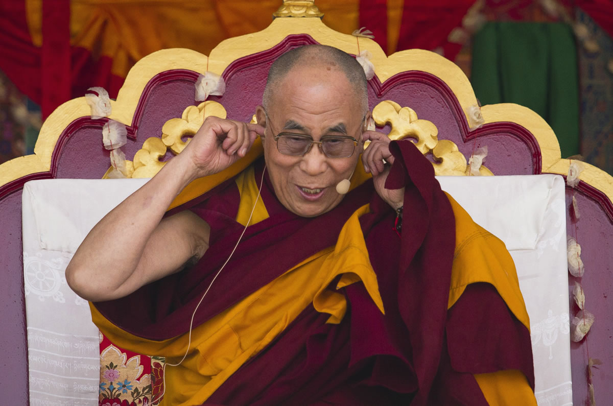 Tibetan spiritual leader the Dalai Lama gestures during a religious talk at the Central School for Tibetans in Dalhousie, about  80 miles north-west of Dharmsala, India, on Saturday.