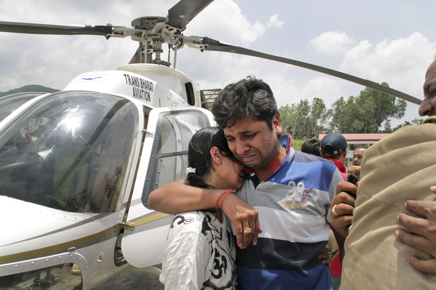 A couple console one another after being evacuated by helicopter Thursday from the upper reaches of Uttrakhand, in Dehradun, India.