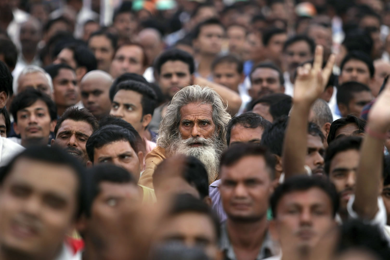 An elderly man listens to a speaker at a political rally in New Delhi.