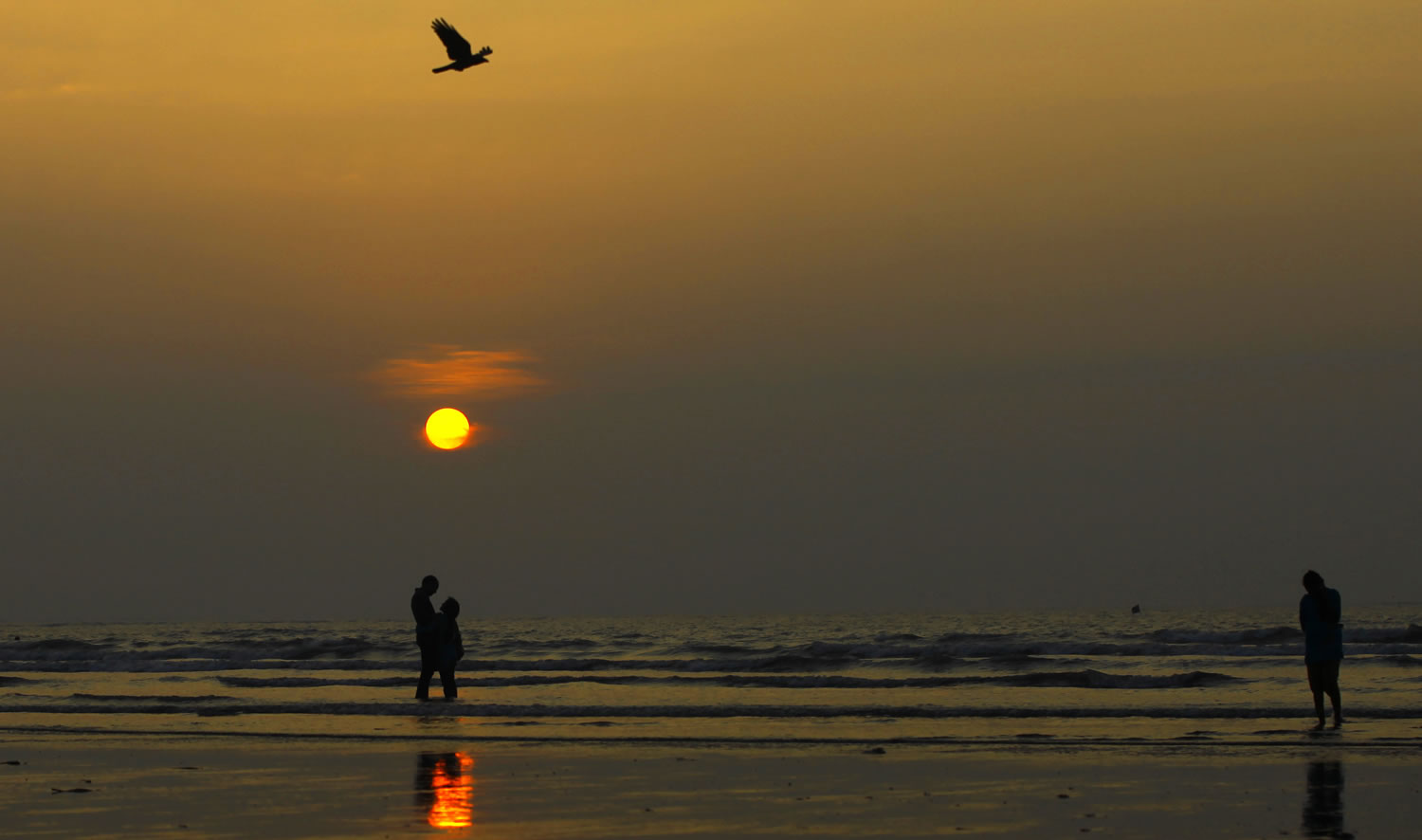 India couple stands as  they watch the last sunset of 2012  over the shores of the Arabian sea in Mumbai, India, Monday, Dec.