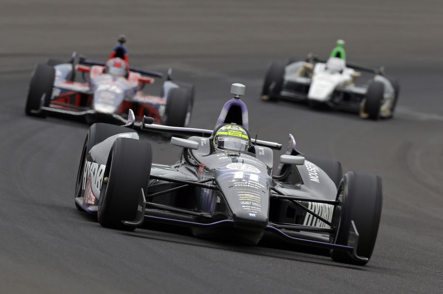 Tony Kanaan, of Brazil, drives through the first turn during the Indianapolis 500.