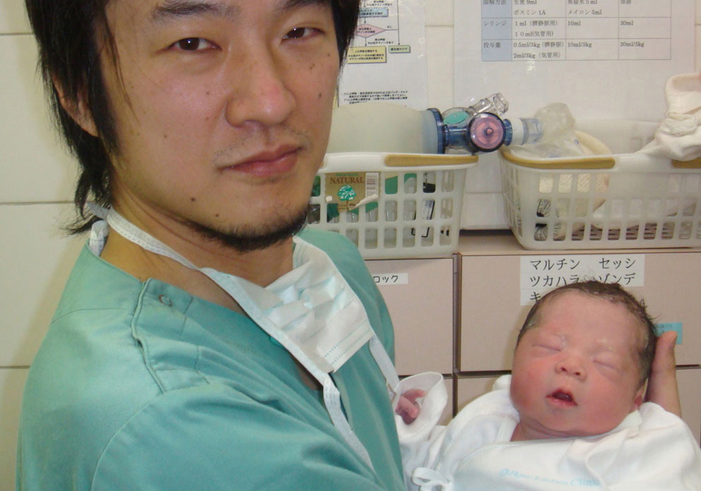 Dr. Kazuhiro Kawamura of the St. Marianna University School of Medicine in Kawasaki, Japan, holds a newborn baby Dec. 28. The child's 30-year-old mother was treated for primary ovarian insufficiency, sometimes called premature menopause.