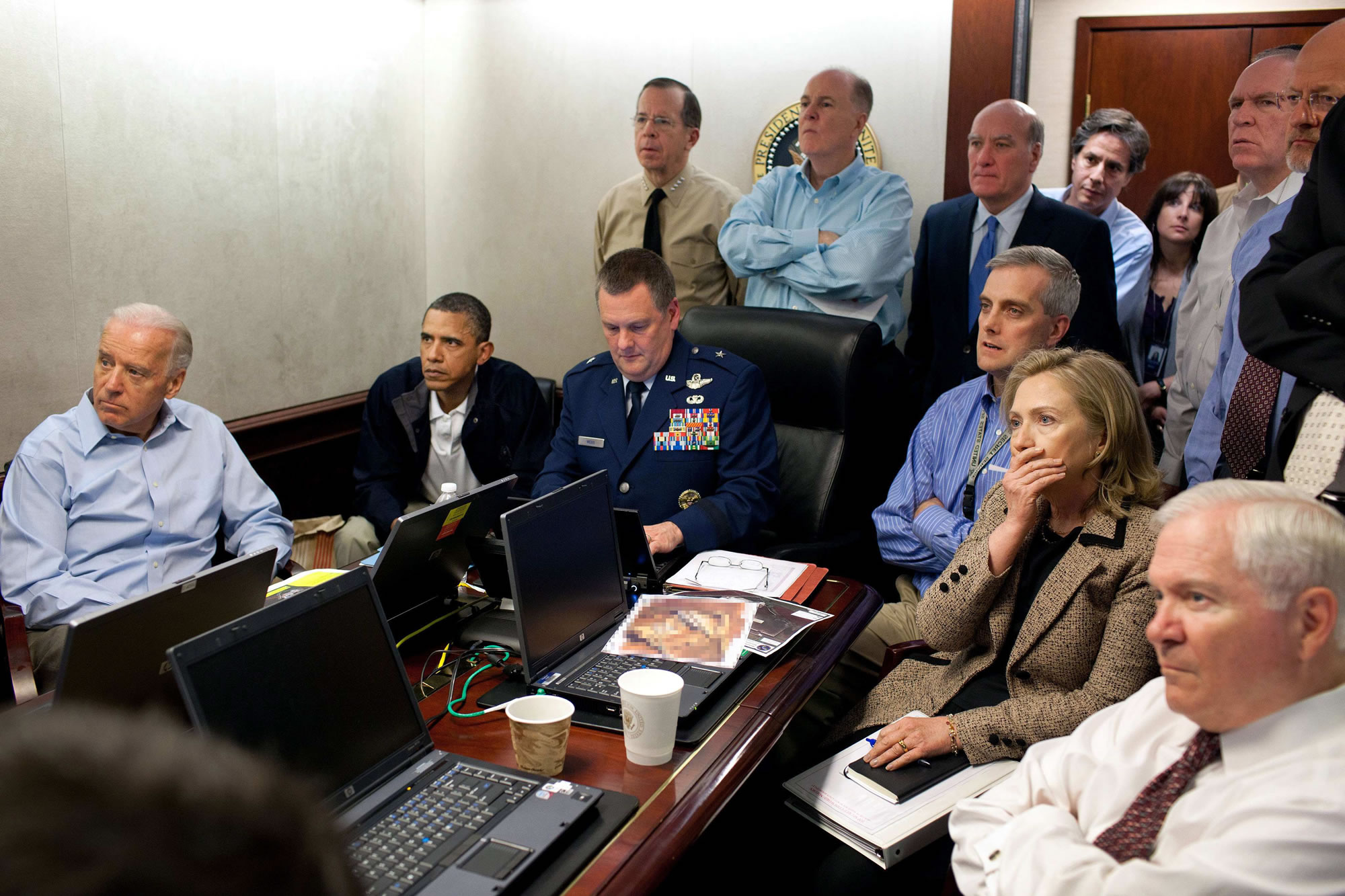Former Secretary of State Hillary Rodham Clinton, right with hand covering mouth, President Barack Obama, second from left, Vice President Joe Biden, left, Secretary of Defense Robert Gates, right, and members of the national security team watch an update of the mission against Osama bin Laden in the White House Situation Room in Washington in 2011.