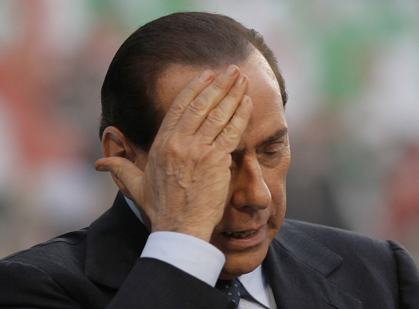 Italian premier Silvio Berlusconi gestures as he attends a meeting in Milan, Italy, on Sept.