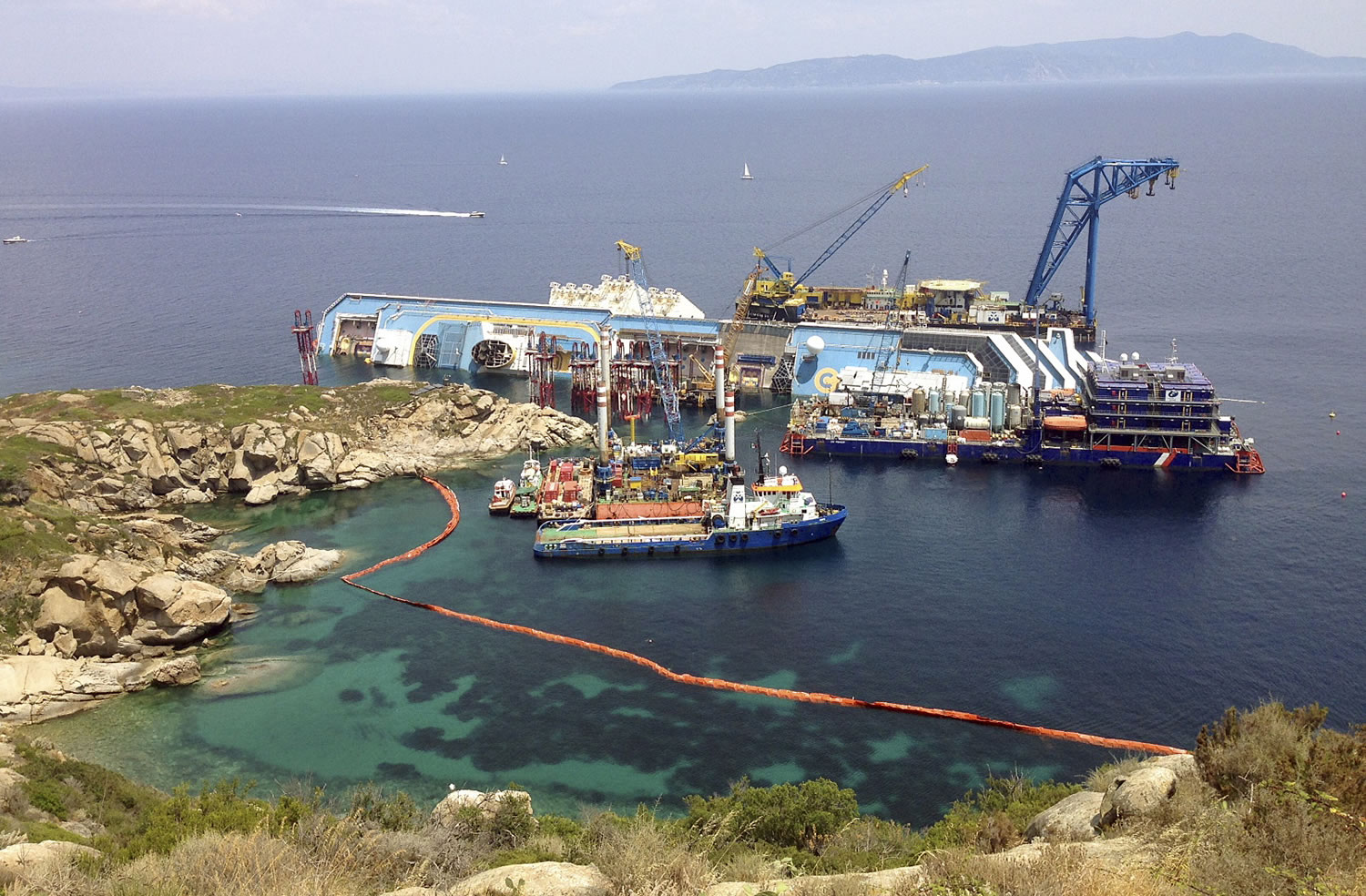 The Costa Concordia rests on its side Monday off the island of Giglio, Italy.