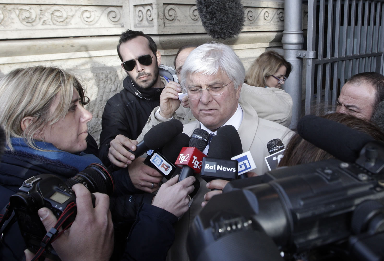 Luciano Ghirga, lawyer for Amanda Knox, center, talks to reporters in front of Italy's Court of Cassation in Rome Monday.