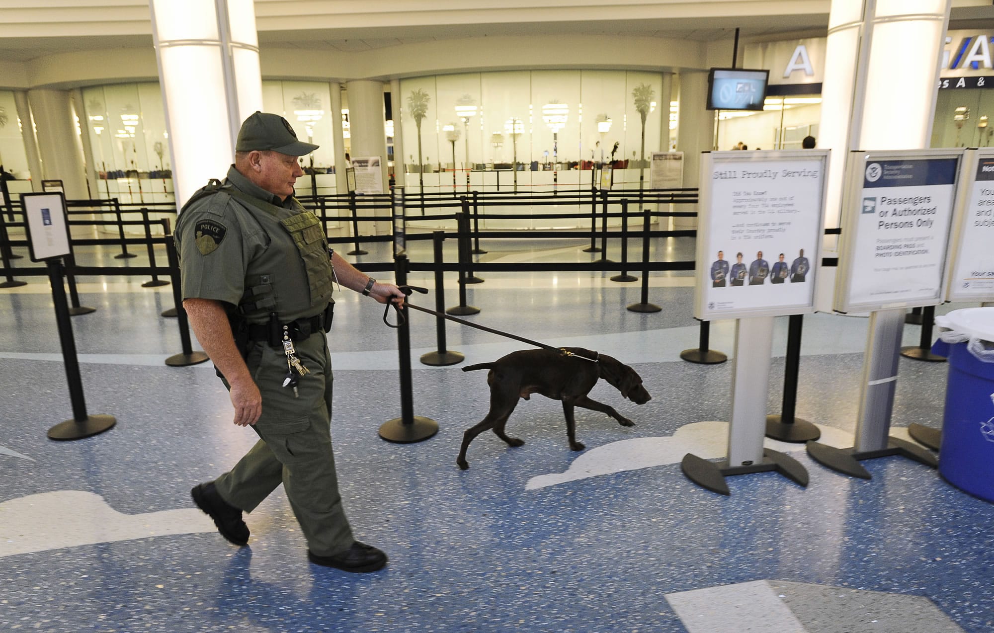 Jacksonville International Airport police officer Tim Hodges walks around the terminal with a bomb dog at Jacksonville International Airport on Wednesday.