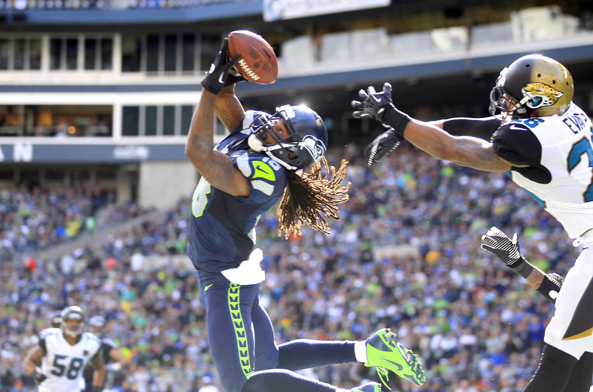 Seattle Seahawks' Sidney Rice, front left, snags the ball in the end zone for a touchdown in front of Jacksonville Jaguars' Josh Evans.