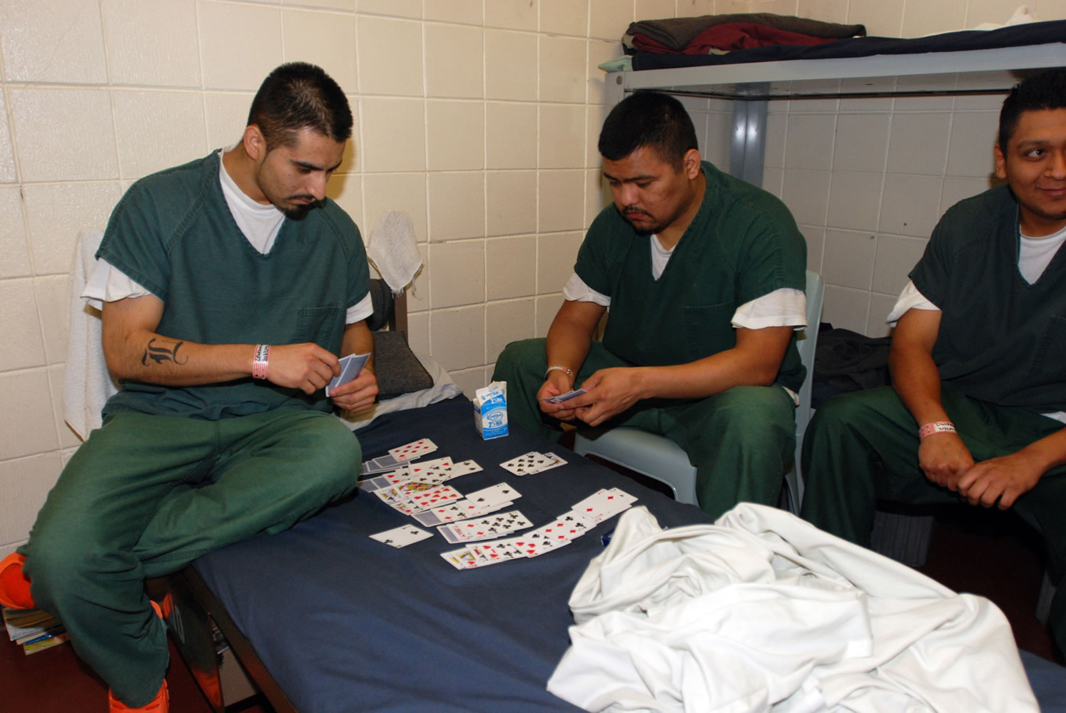 Inmates play cards in the Lane County Jail in Eugene, Ore.