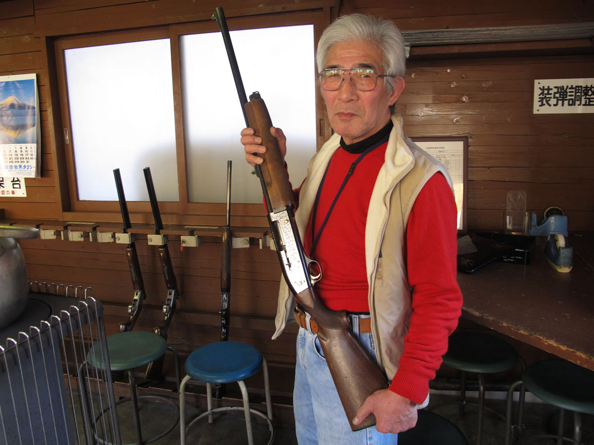 Japanese rifle enthusiast Yasuharu Watabe displays his gun at a shooting range in Ooi, near the foot of Mount Fuji.