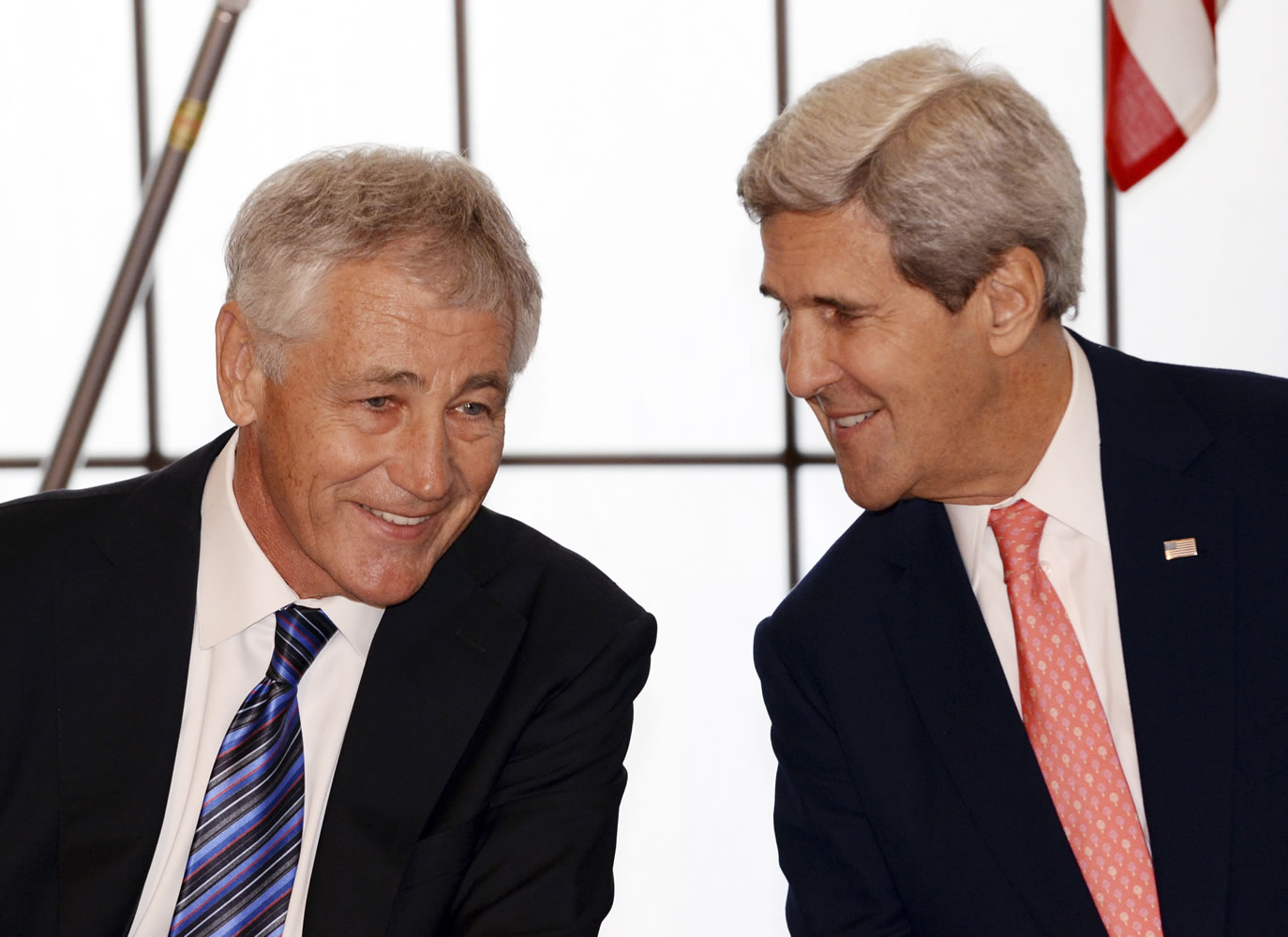 U.S. Secretary of Defense Chuck Hagel, left, listens to U.S. Secretary of State John Kerry prior to the signing ceremony after U.S.