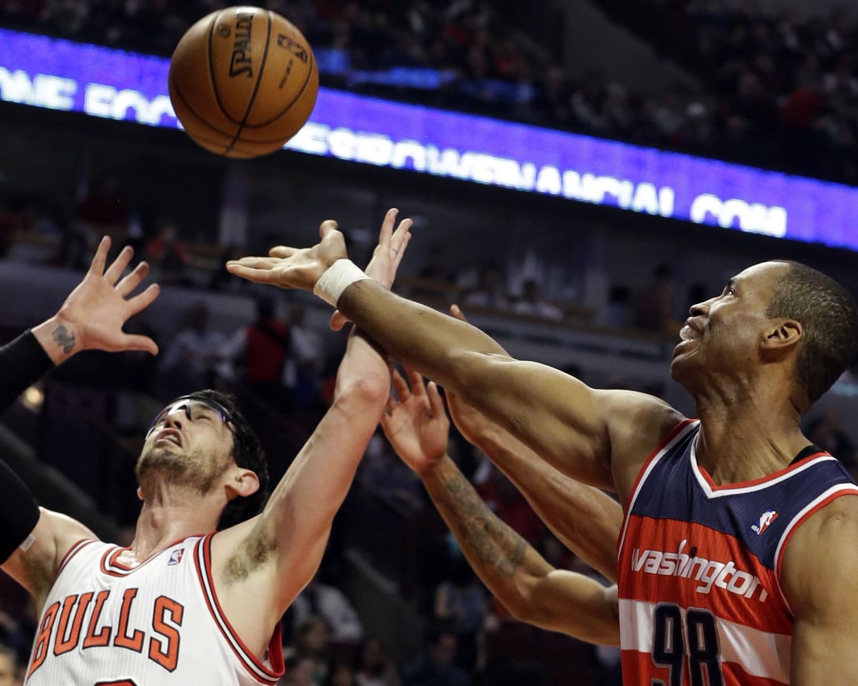 Washington Wizards center Jason Collins, right, battles for a rebound April 17 against Chicago Bulls guard Kirk Hinrich during the first half of an NBA basketball game in Chicago.
