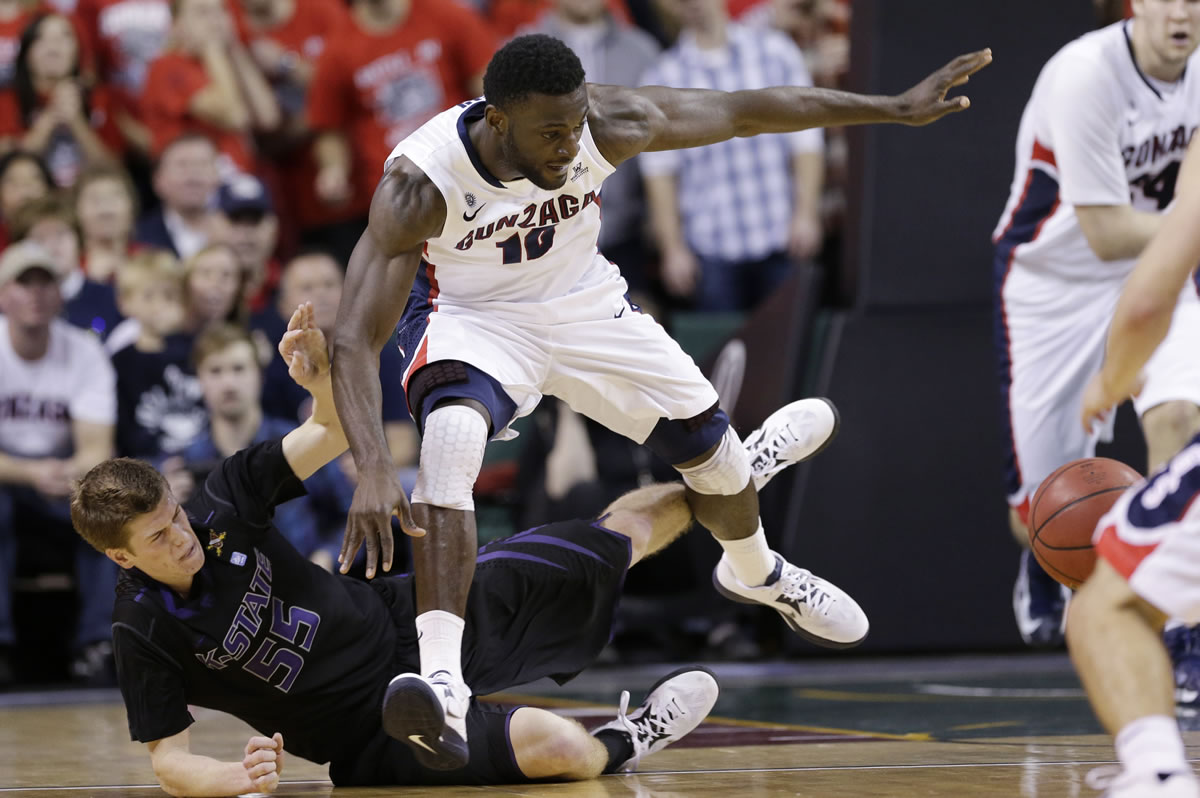 Kansas State's Will Spradling, left, tumbles after bumping into Gonzaga's Guy Landry Edi as the two raced for a loose ball in Gonzaga's win.
