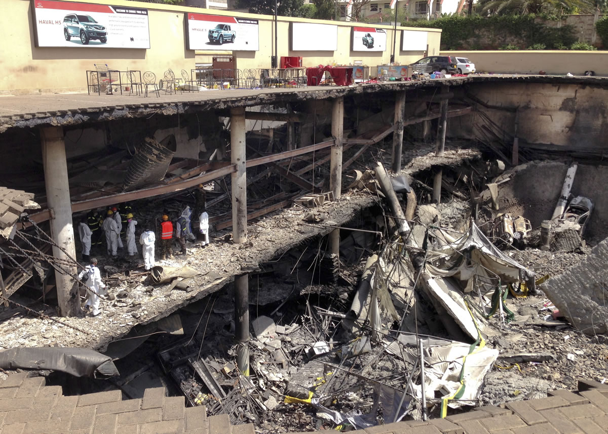 Forensics investigators work next to the collapsed upper car park at the Westgate Mall in Nairobi, Kenya, on Tuesday.