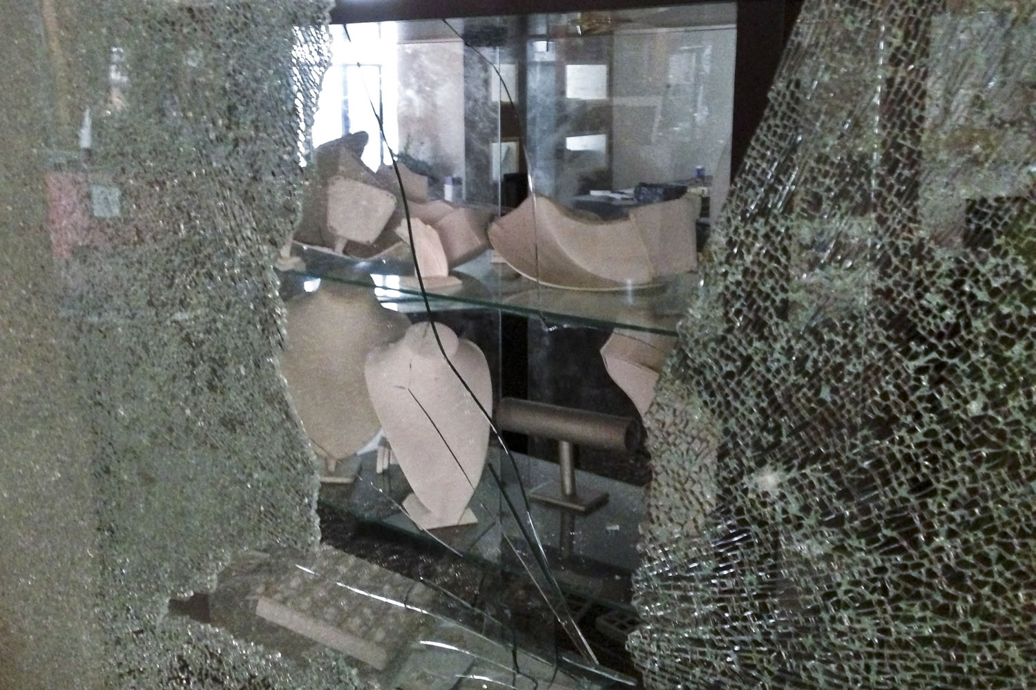 Empty displays are visible behind the shattered window of a jewelry store Tuesday at the Westgate Mall in Nairobi, Kenya.