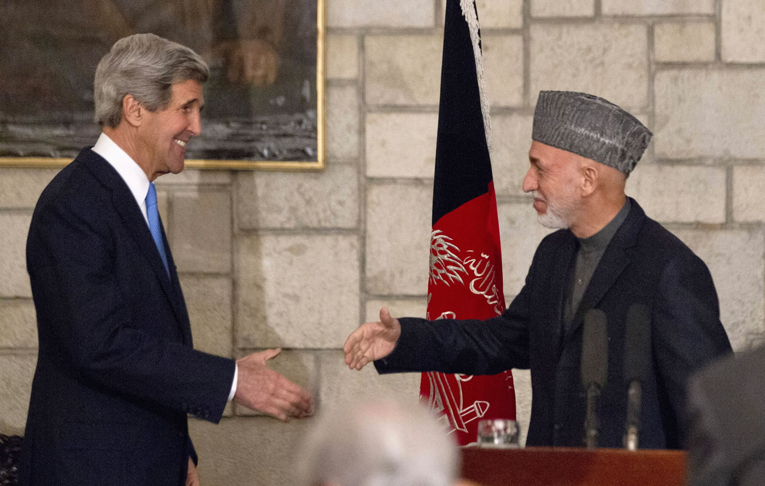 Secretary of State John Kerry shakes hands with Afghan President Hamid Karzai at the end of their joint news conference at the Presidential Palace in Kabul on Monday.