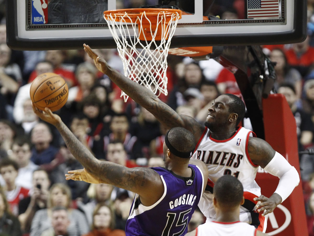 Sacramento Kings center DeMarcus Cousins, left, goes to the hoop against Portland Trail Blazers center J.J. Hickson during the second half of their NBA basketball game in Portland, Ore., Saturday, Dec. 8, 2012.