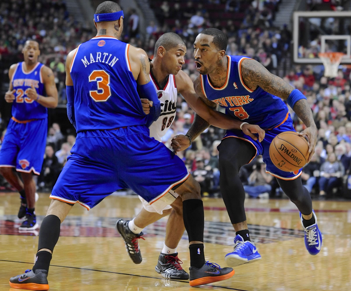 New York Knicks' J.R. Smith (8), with a screen by teammate Kenyon Martin (3), drives against Portland Trail Blazers' Nicolas Batum (88) during the first half of an NBA  basketball game in Portland, Ore., Thursday, March 14, 2013.