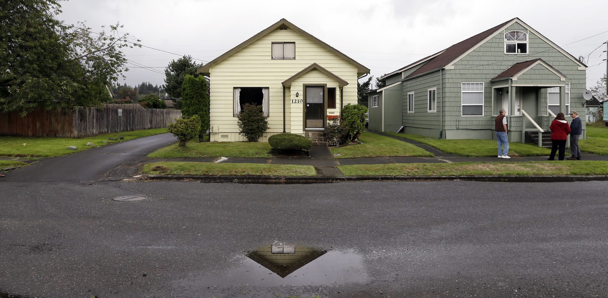 The childhood home of Kurt Cobain, the late frontman of Nirvana, left, is shown Monday along an alley in Aberdeen. Cobain's mother is putting the 1.5-story Aberdeen bungalow on the market this week, the same month as the 20th anniversary of Nirvana's final studio album. The home, last assessed at less than $67,000, is being listed for $500,000, but the family would also be happy entering into a partnership with anyone who wants to turn it into a museum.