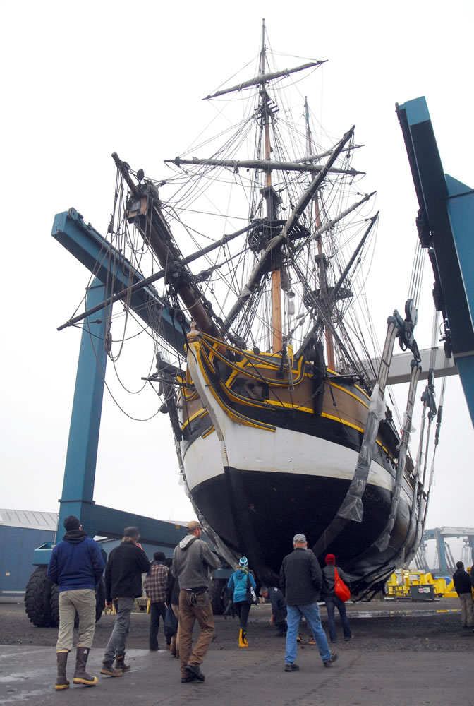 Crew members of the Lady Washington approach its keel Saturday in Port Angeles for hull inspection. The U.S. Coast Guard called for the inspection after the 112-foot ship ran aground on Thursday night at the entrance to the marina in Westport.