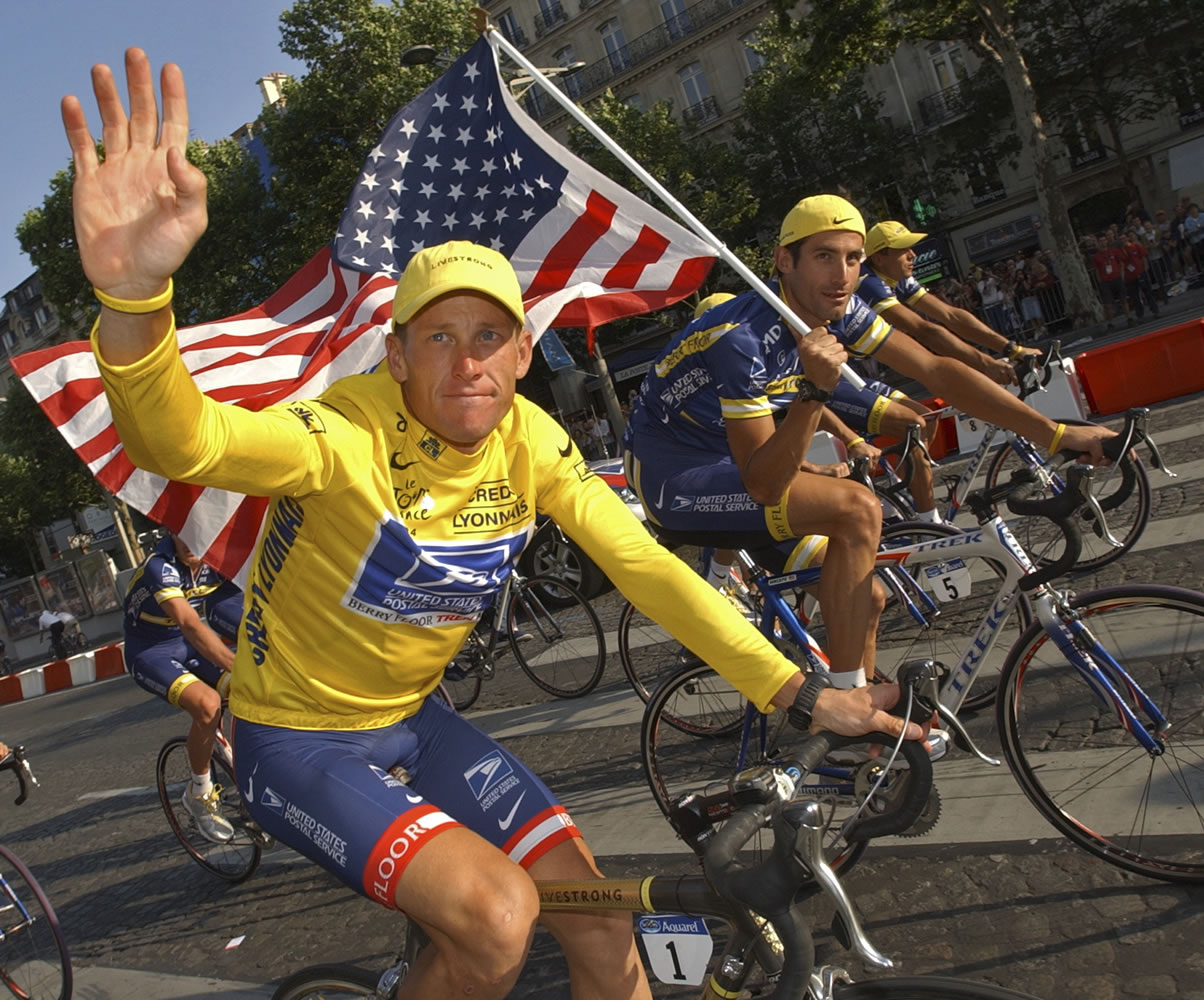 U.S. Postal Service cycling team leader and 2004 Tour de France winner Lance Armstrong, wearing the overall leader's yellow jersey, and teammate George Hincapie, right, ride the victory lap on Champs Elysees boulevard in Paris, France on July 25, 2004. Lawyers for Armstrong say the Justice Department has joined a lawsuit against the cyclist. The lawsuit alleges the former Tour de France champion concealed his use of performance-enhancing drugs for over a decade and defrauded his long-time sponsor, the U.S.