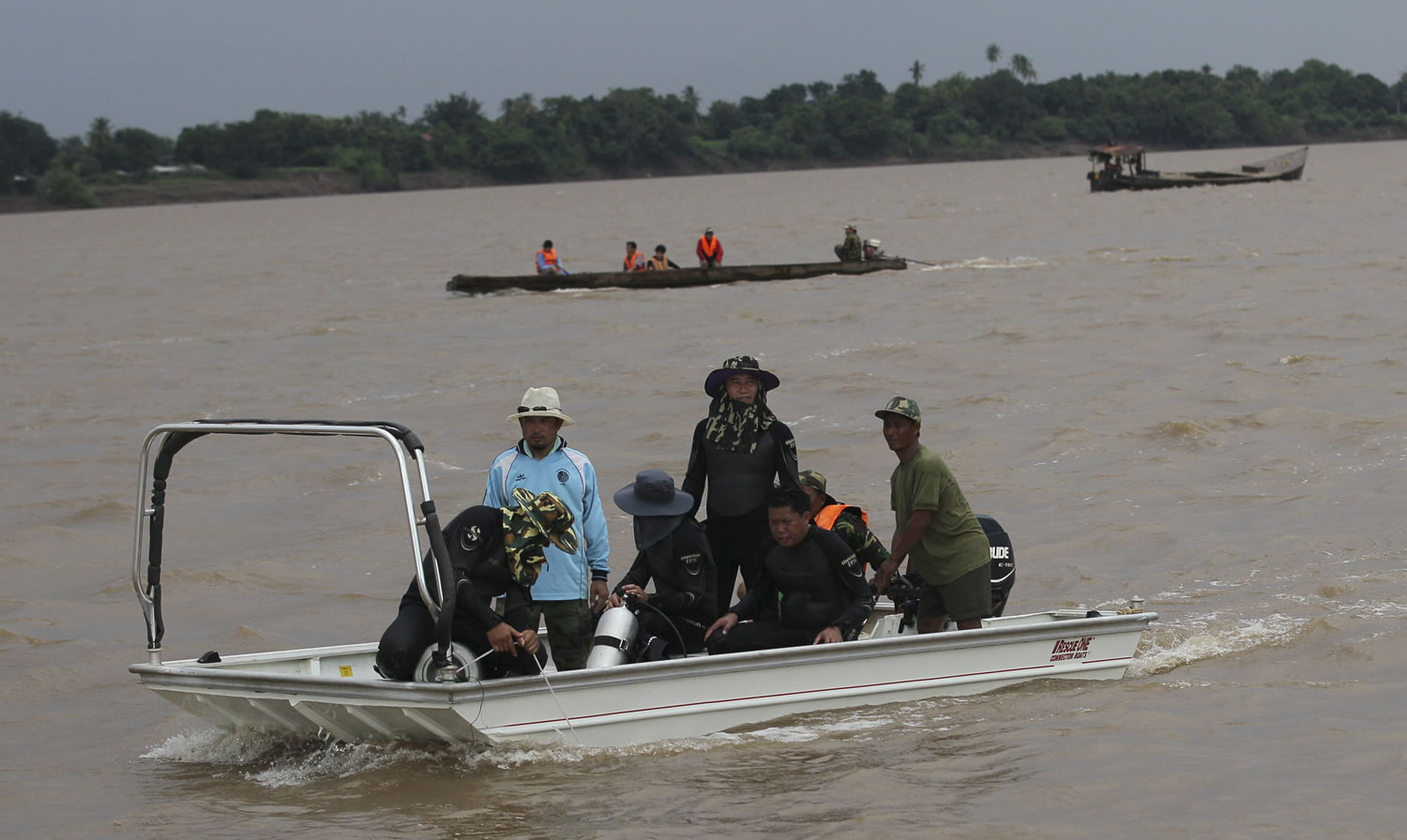 Rescue workers search bodies of plane crash victims by boats in the Mekong River in Pakse, Laos, on Friday.