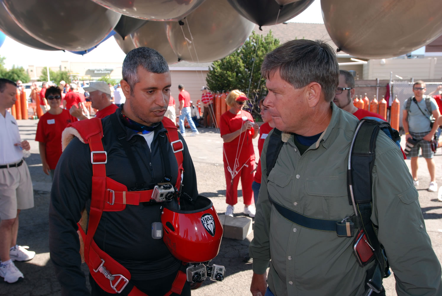 FILE - This July 14, 2012 file photo shows gas station owner Kent Couch, right, conferring with Iraqi adventurer Fareed Lafta before taking off from Bend, Ore., in tandem lawn chairs suspended from helium-filled party balloons. Couch says his lawn chair ballooning days are probably done, at least in the U.S., due to the high price of helium and a $4,500 fine from the Federal Aviation Administration over the 2012 flight with Lafta.