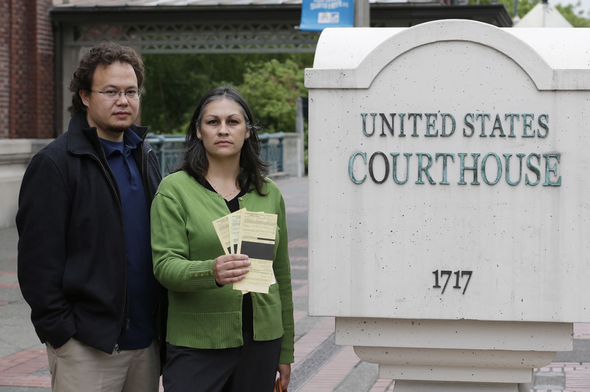 Thomas and Karen Strand of Centralia pose for a photo outside the federal courthouse in Tacoma after they made their initial appearance on charges stemming from two traffic stops in Olympic National Park where they were carrying a small amount of medical marijuana in a sealed container in their vehicle.