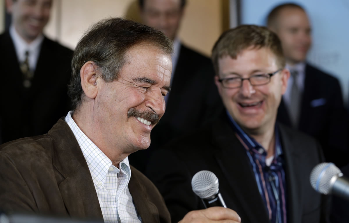 Former Mexican President Vicente Fox, left, speaks as Jamen Shively, CEO of Diego Pellicer, looks on during a news conference Thursday in Seattle.