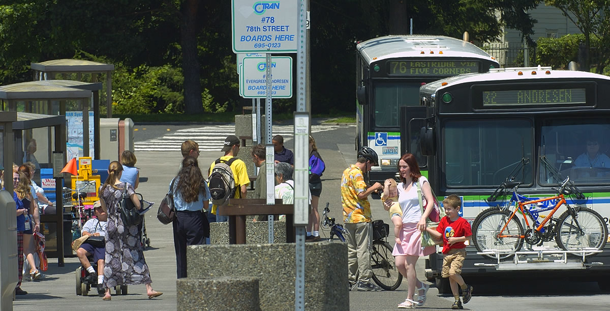 Passengers line up to board a C-Tran bus at the Vancouver mall in August 2005.