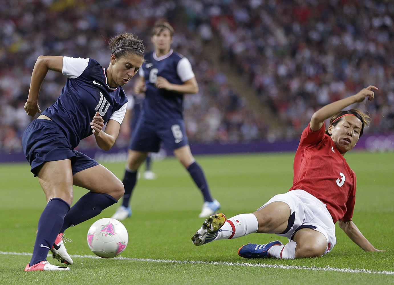 United States' Carli Lloyd (10) and Japan's Azusa Iwashimizu (3) fight for control of the ball during the women's soccer gold medal match at the 2012 Summer Olympics in London.