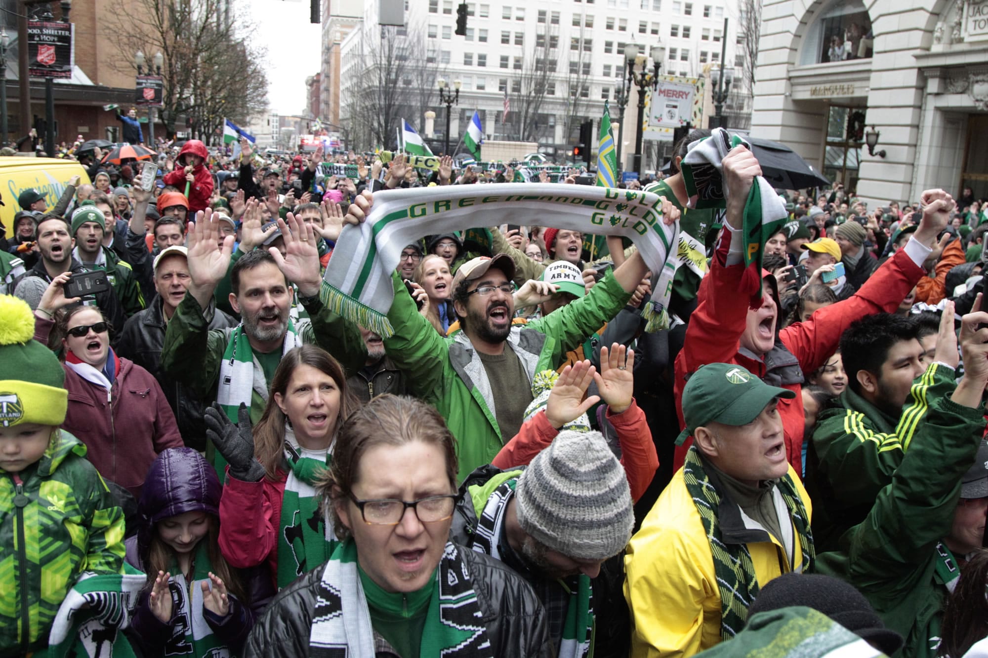 Fans cheer during the MLS champion Portland Timbers parade through Portland, Ore., Tuesday, Dec. 8, 2015.  The Timbers defeated the Columbus Crew 2-1 Sunday in the MLS Cup soccer final.