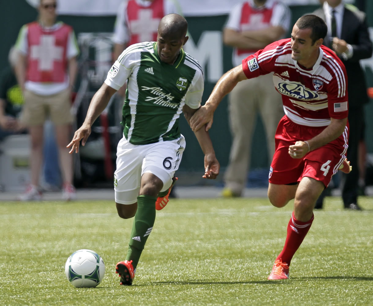 Portland Timbers forward Darlington Nagbe, left, and FC Dallas midfielder Andrew Jacobson chase down the ball during the first half Saturday.