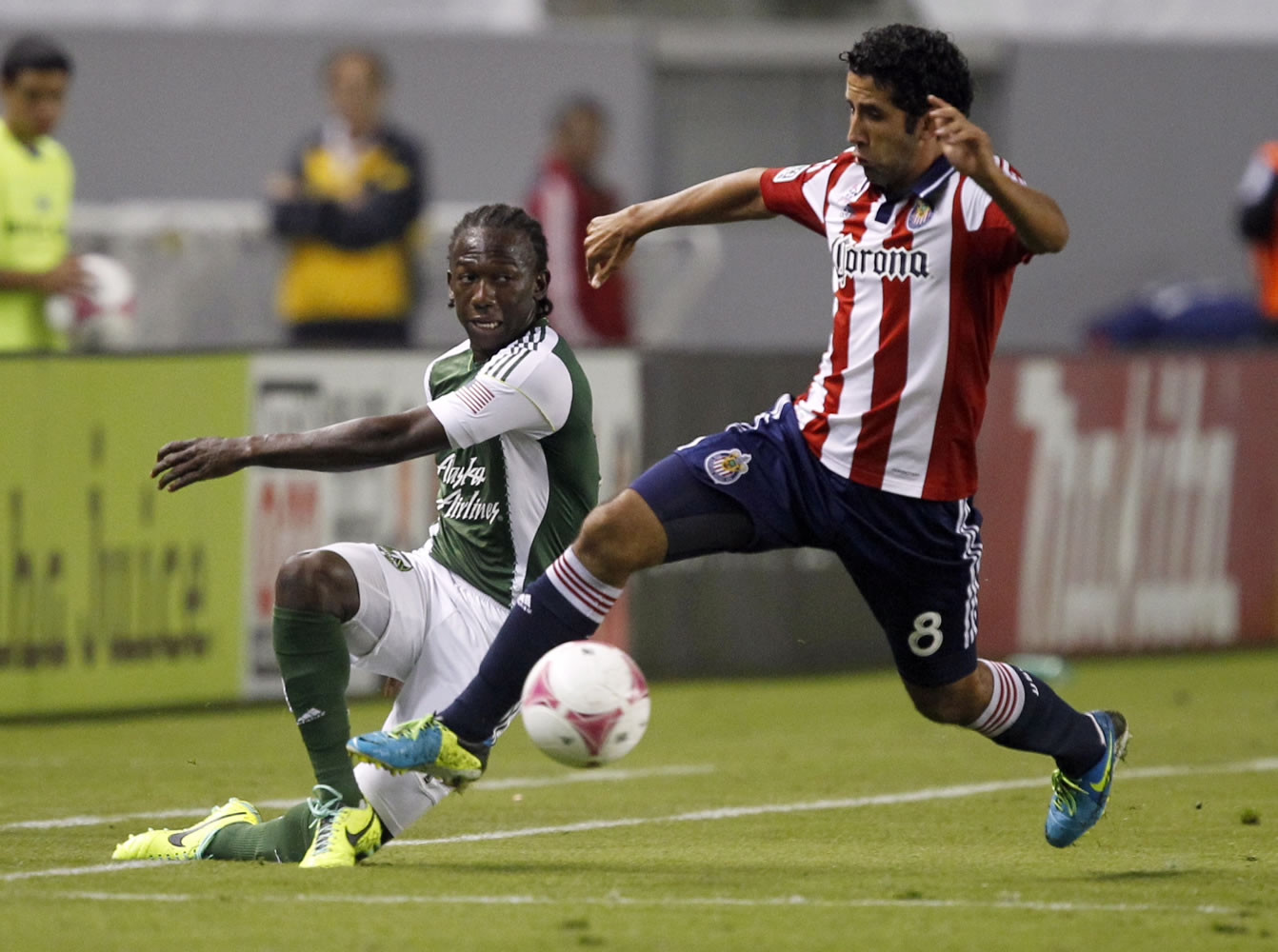 Portland Timbers midfielder Darlington Nagbe, left, gets a pass by Chivas USA midfielder Oswaldo Minda (8) during the first half Saturday. The Timbers won the match 5-0.