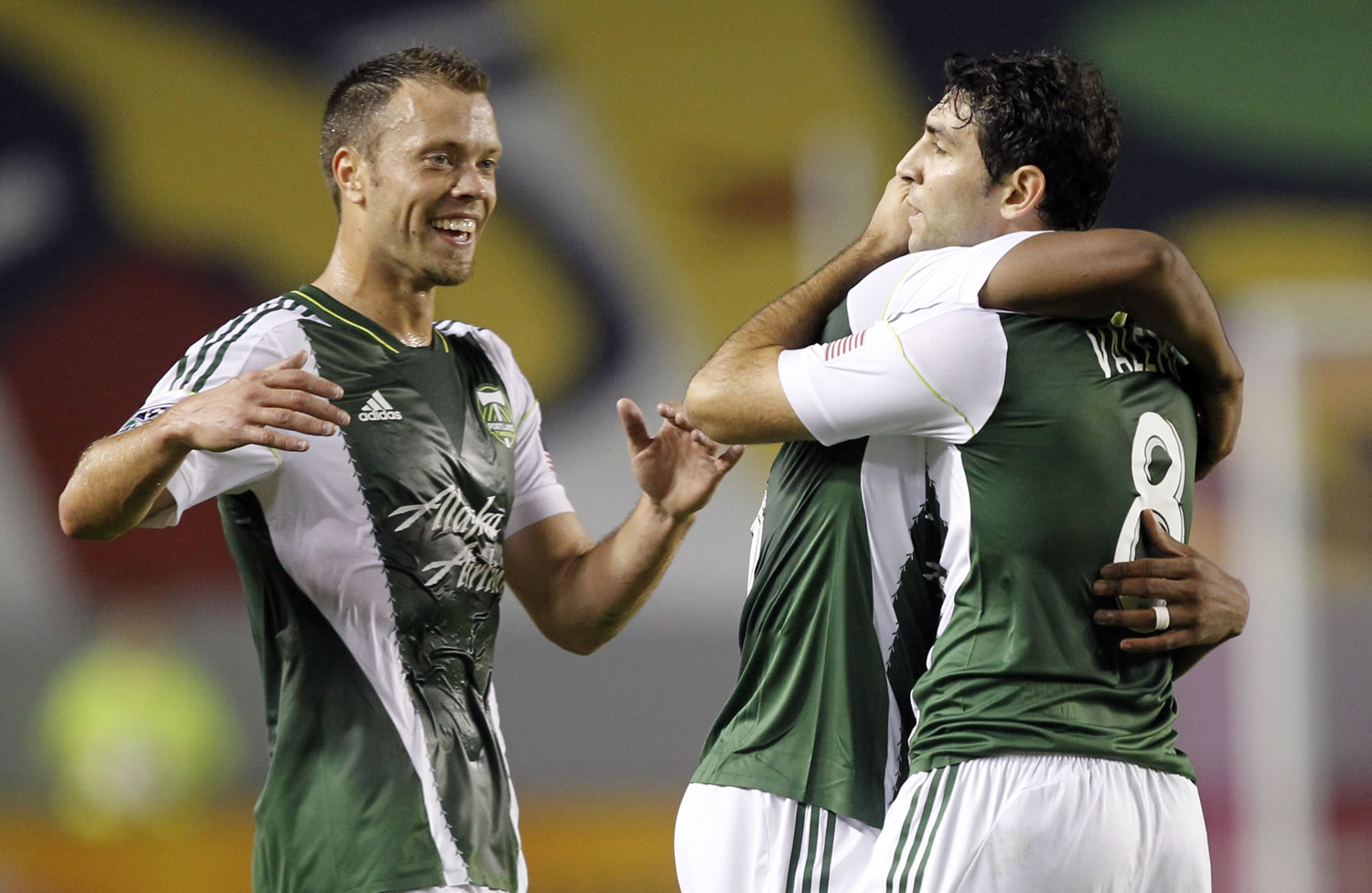 Portland Timbers defender Jack Jewsbury, left, comes in to celebrate with Timbers midfielder Darlington Nagbe, center, after Portland Timbers forward Diego Valeri's, right, second goal against Chivas USA during the first half of an MLS soccer match, Saturday, Oct. 26, 2013, in Carson, Calif.