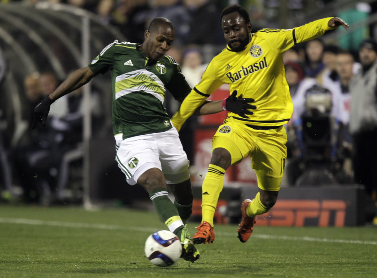Portland Timbers forward Darlington Nagbe, left, and Columbus Crew midfielder Cedrick Mabwati fight for the ball during the second half of the MLS Cup championship soccer game Sunday, Dec. 6, 2015, in Columbus, Ohio. The Timbers won 2-1.