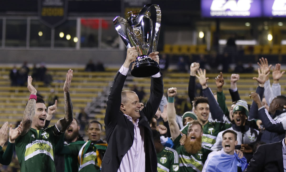 Portland Timbers owner Merritt Paulson raises the trophy after the Timbers defeated the Columbus Crew 2-1 in the MLS Cup championship soccer game Sunday, Dec. 6, 2015, in Columbus, Ohio.