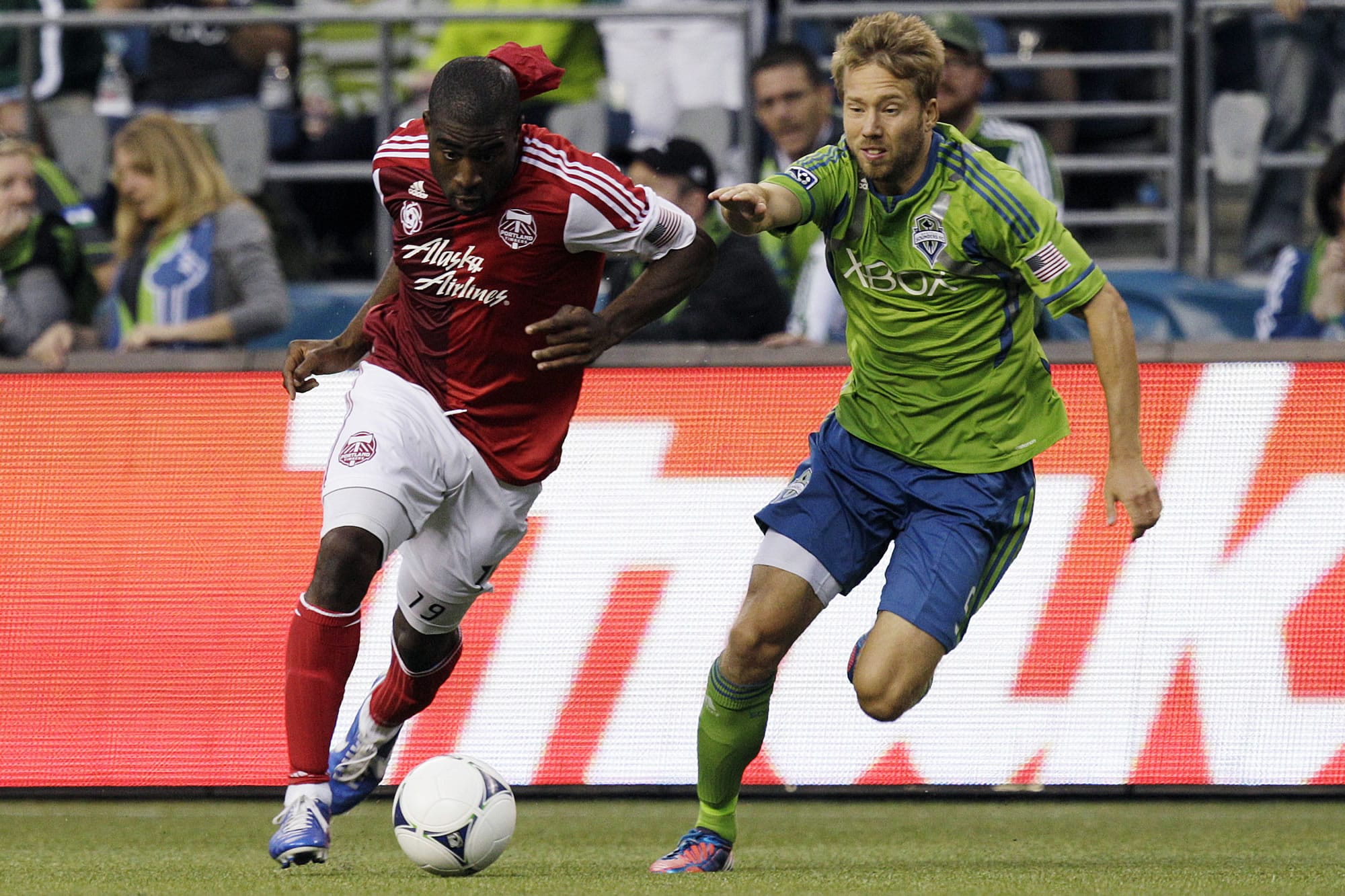 Portland Timbers' Bright Dike, left, drives toward the goal as Seattle Sounders' Adam Johansson, right, defends, in the first half Sunday.