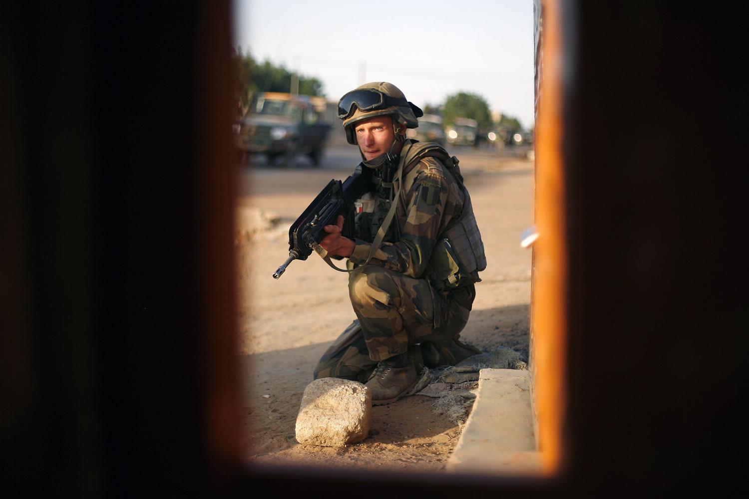 A French soldier takes position Sunday as forigners are evacuated during exchanges of fire with jihadists in Gao, northern Mali.