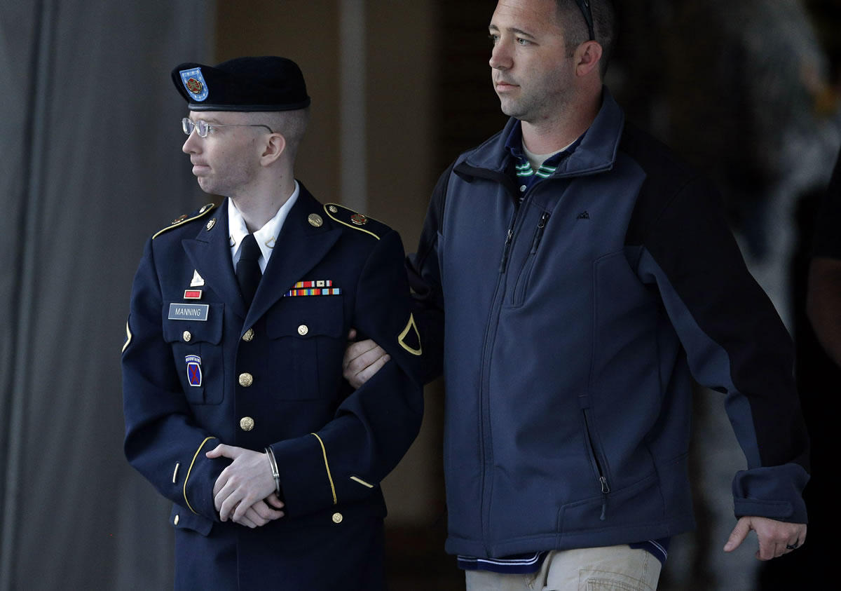 Army Pfc. Bradley Manning, left, is escorted to a security vehicle outside of a courthouse in Fort Meade, Md., Monday after the third day of deliberations in his court martial.