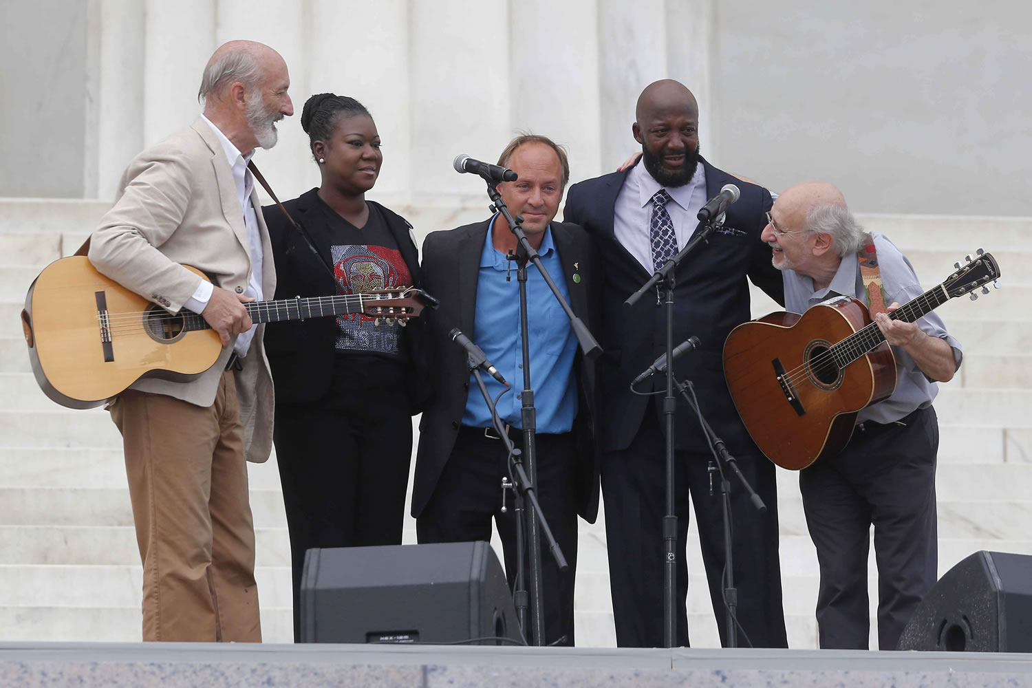 With Trayvon Martin's parents, Sybrina Fulton and Tracy Martin, Peter Yarrow, left, and Paul Stookey, right, of the folk trio Peter, Paul and Mary, perform at the 50th Anniversary of the March on Washington where Martin Luther King, Jr., spoke Wednesday , in front of the Lincoln Memorial in Washington.
