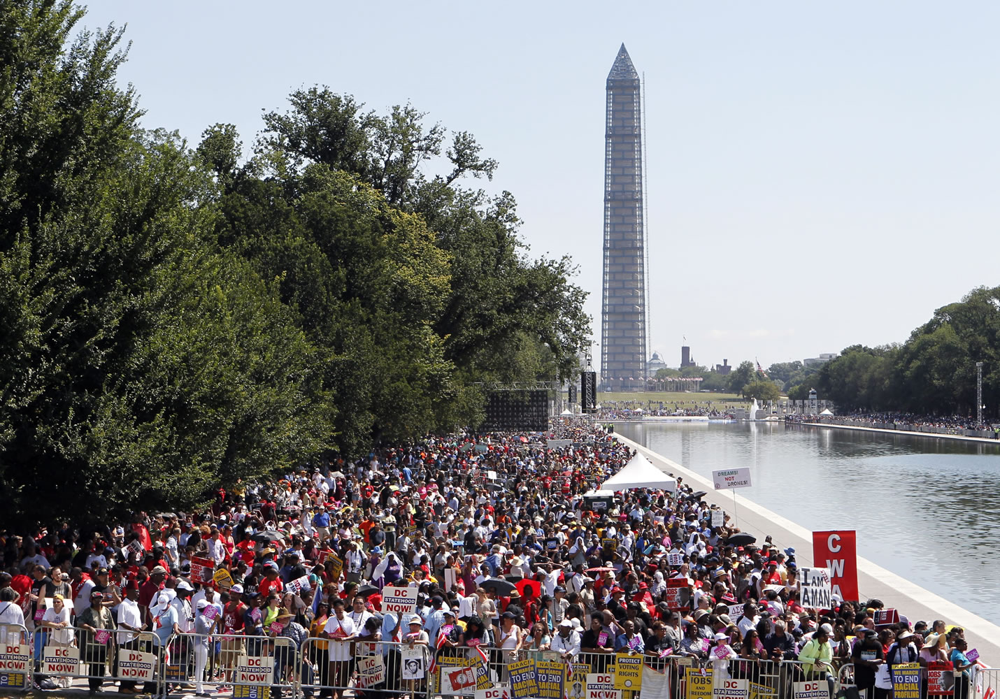 People line the Reflecting Pool during Saturday's rally to commemorate the 50th anniversary of the 1963 March on Washington.