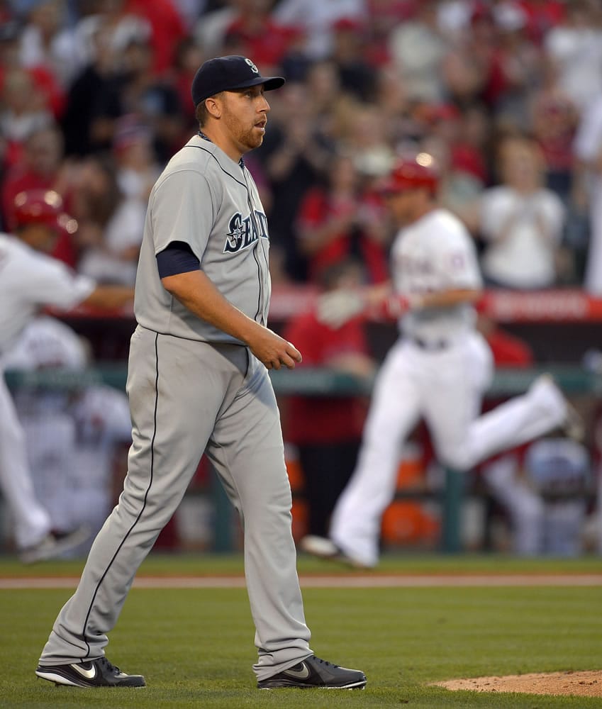 Seattle Mariners starting pitcher Aaron Harang (39) reacts after giving up a two-run home run to Los Angeles Angels' Josh Hamilton (32) in the second inning Monday.