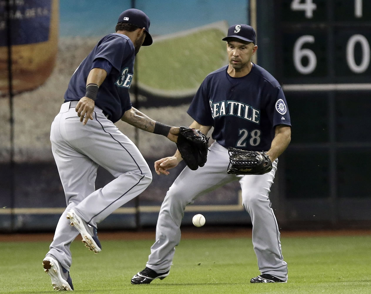 The ball drops between left fielder Raul Ibanez (28) and shortstop Brendan Ryan in a 3-2 loss at Houston.